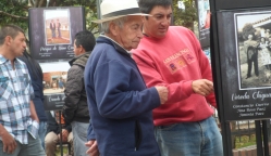 Dos hombres observando las fotografías expuestas en el parque de Usme pueblo